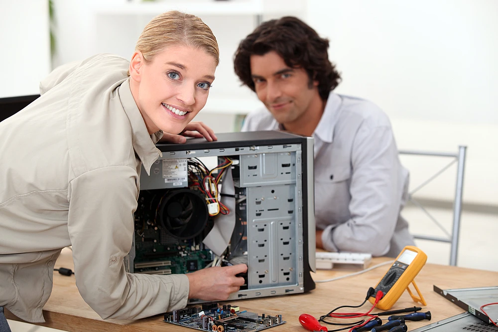 Well trained computer technicians fixing a computer hardware